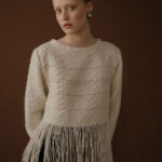 Woman wearing sweater with fringes