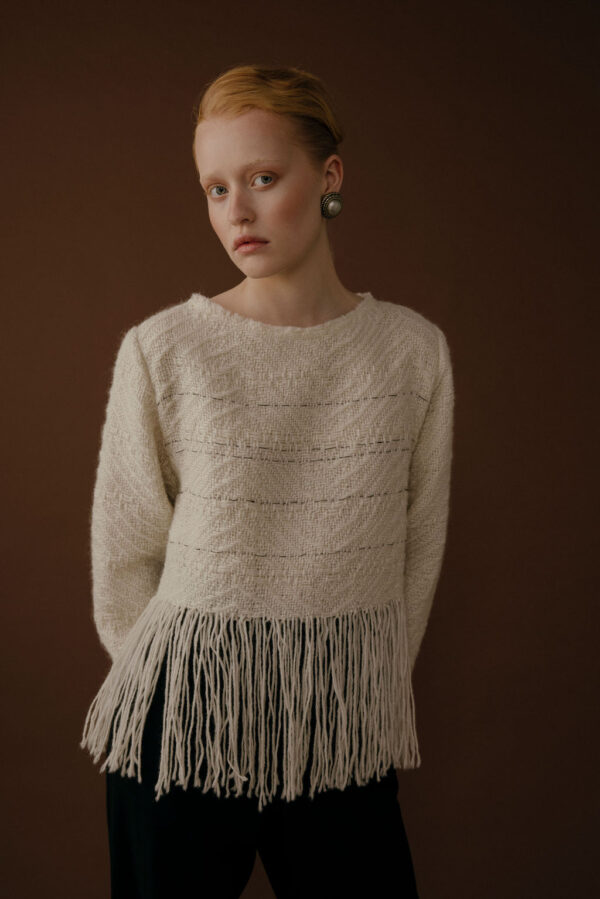 Woman wearing sweater with fringes