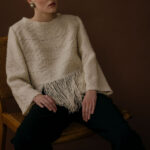 Women wearing sweater with fringes