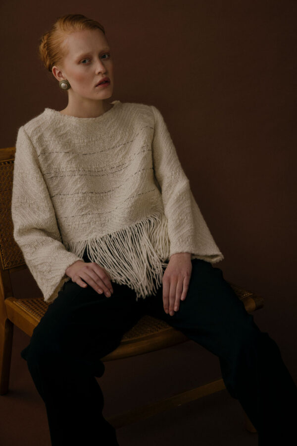 Women wearing sweater with fringes
